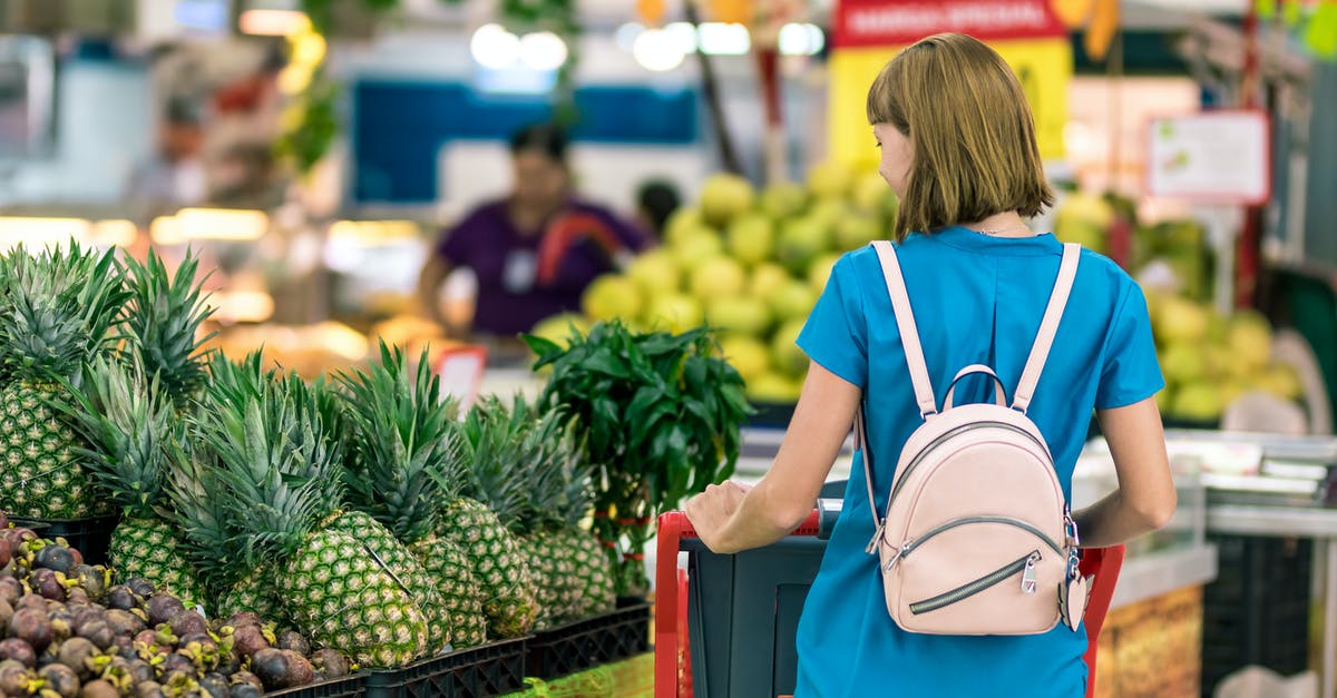 Why is grocery store celery trimmed of its leaves? - Woman Standing Beside Pineapple Fruits