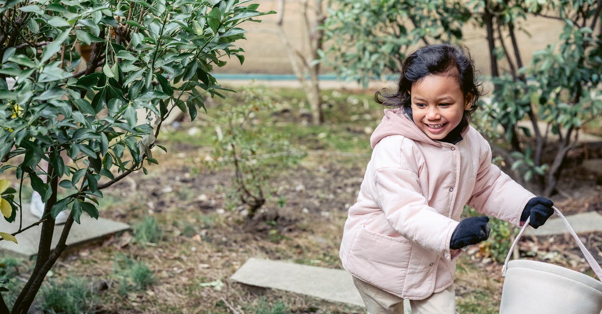 Why is it easier to separate a cold egg? - Smiling ethnic girl with soft bucket running in spring garden