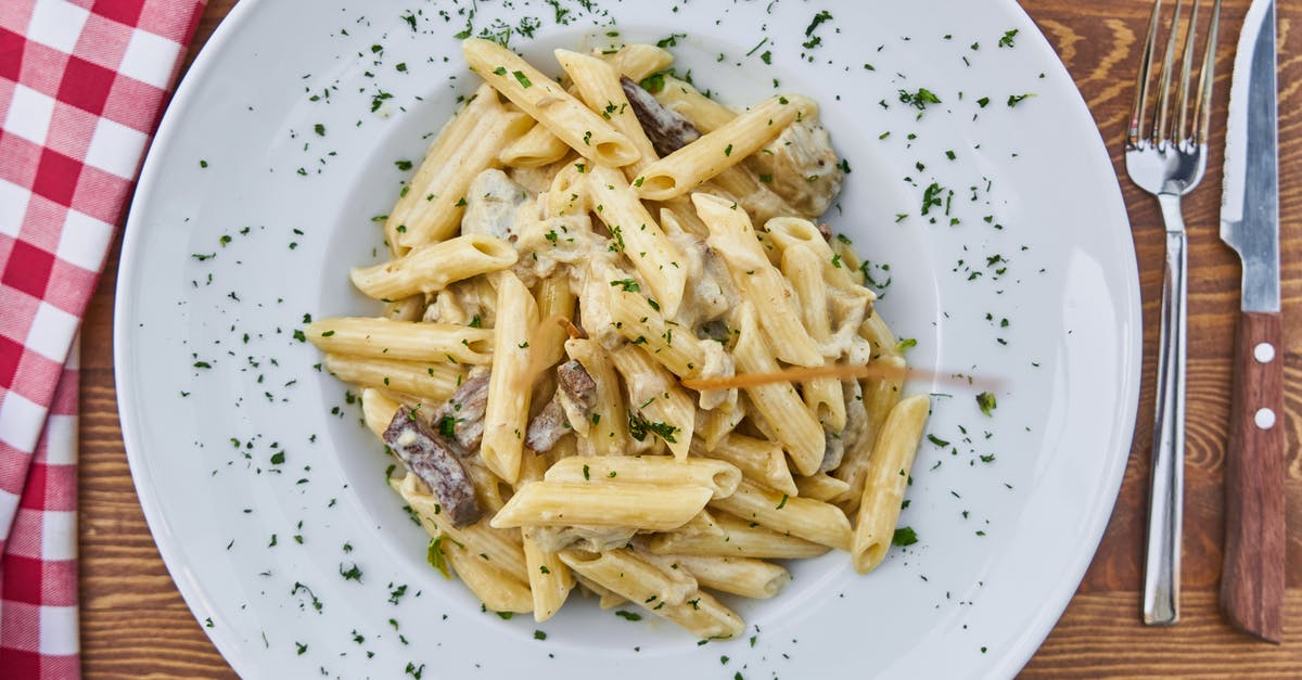 Why is my cheese sauce gritty? - Flat Lay Photography of Pasta Served in White Plate