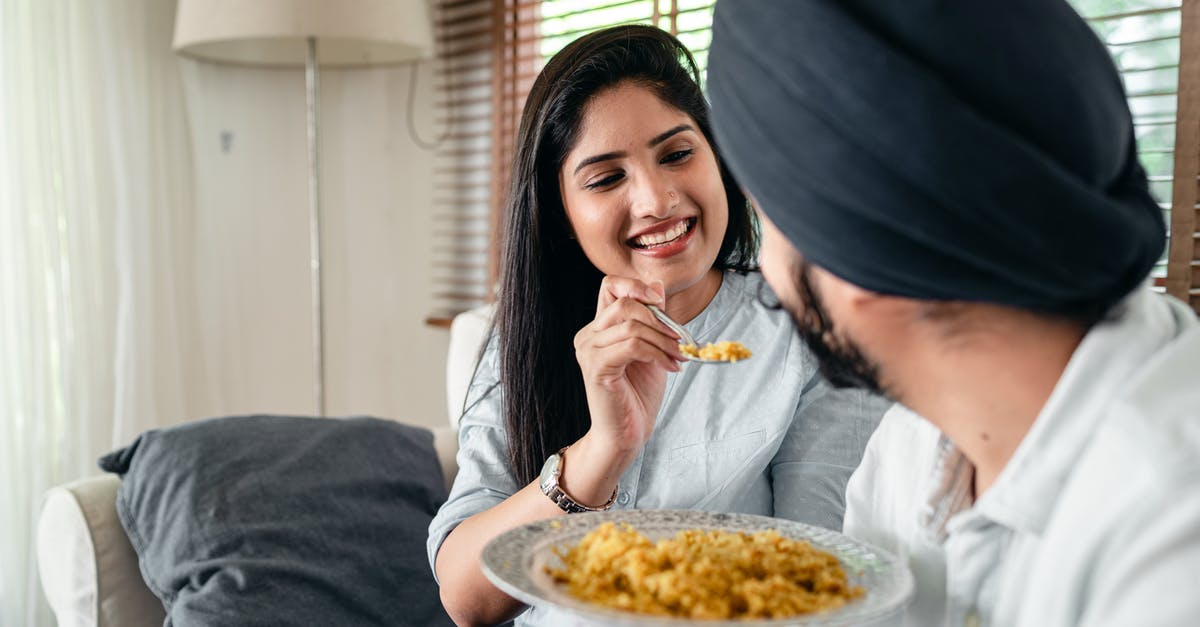 Why is the chicken in Indian food so tender? - Smiling woman feeding man in turban