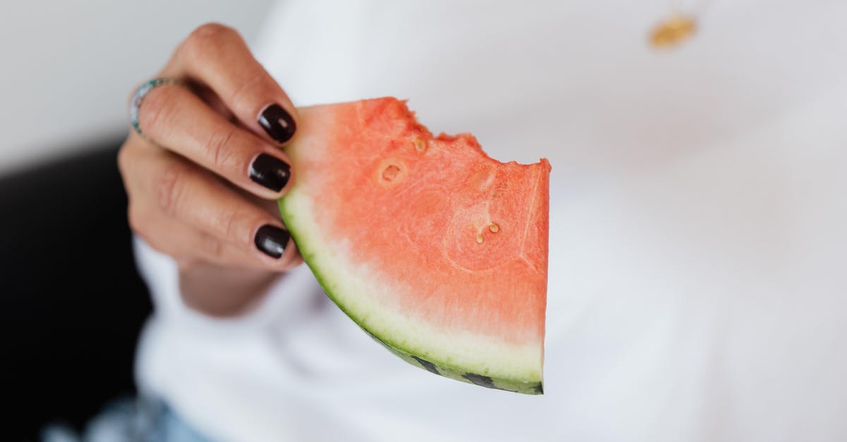 Why isn't it safe to eat raw chicken? - Crop unrecognizable female with manicure in white t shirt eating sweet juicy watermelon