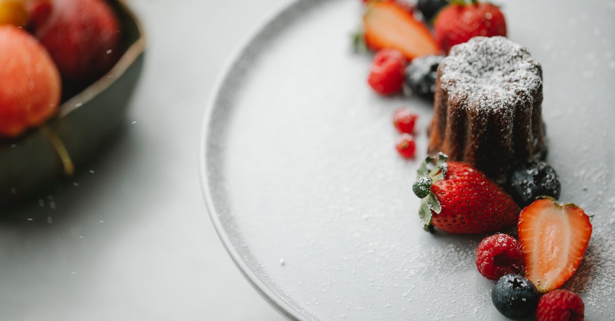 Why not blind bake with two pie plates? - From above of palatable homemade pie sprinkled with icing sugar placed on round plate on table near blurred bowl in kitchen