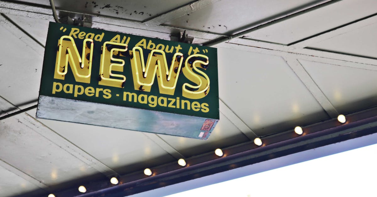 Why not stir the french press using a metal spoon? - From below of illuminated signboard with news papers magazines inscriptions hanging on metal ceiling on street