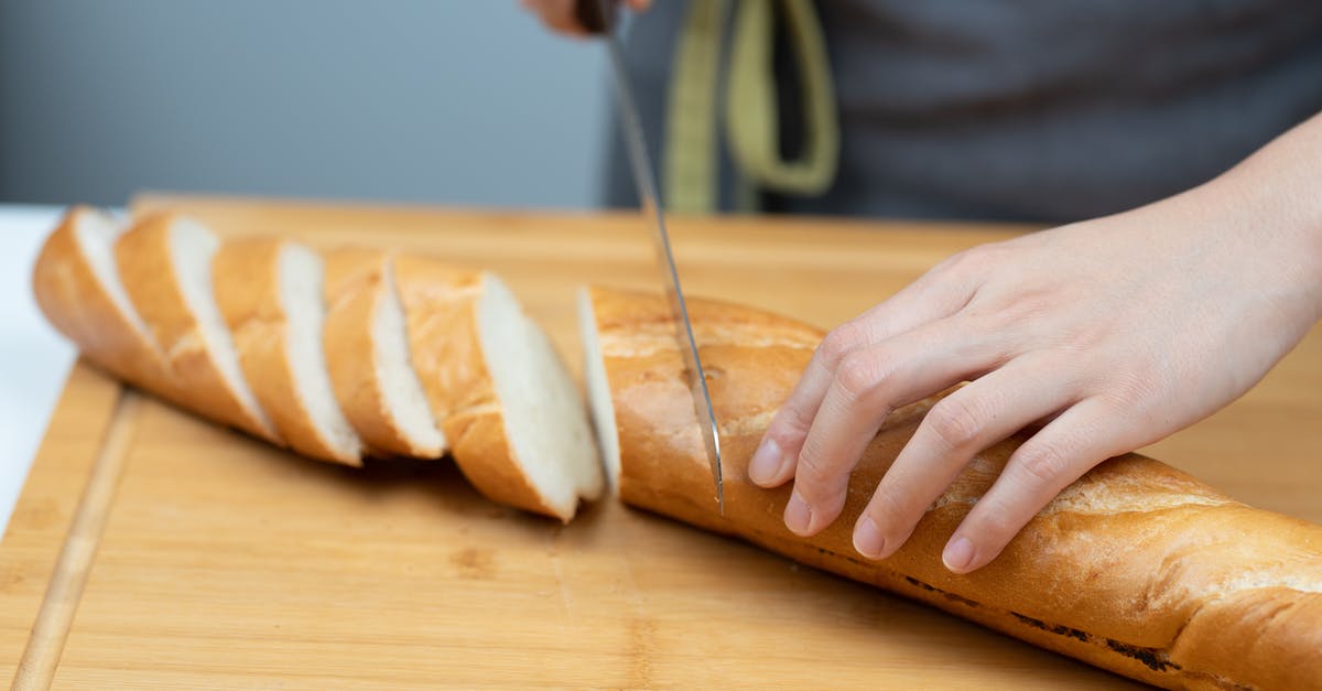 Why proof a baguette seam side up - Person Slicing Bread on Brown Wooden Chopping Board