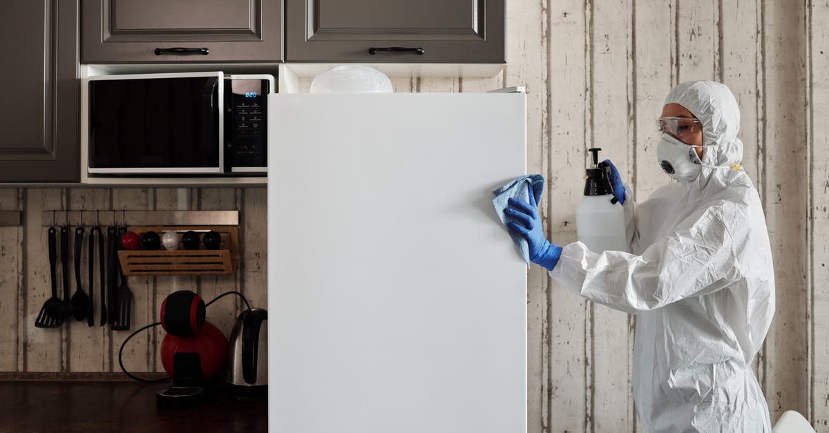 Why rinse basmati rice? - Photo Of Person Disinfecting The Kitchen