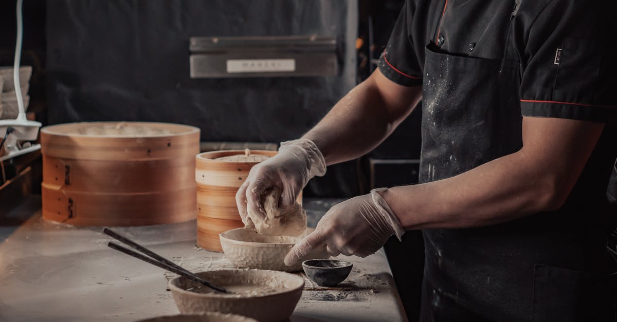 Why should I cook the flour first when making bechamel sauce? - Person Wearing White Gloves Holding a Dough