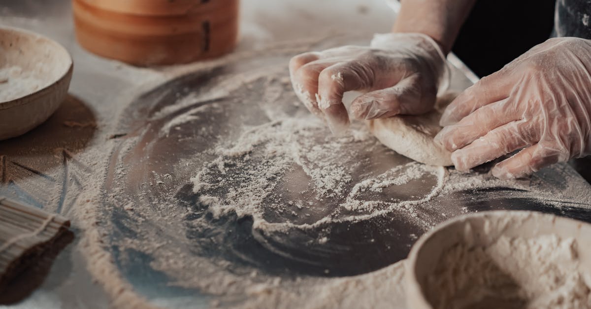 Why should I cook the flour first when making bechamel sauce? - Person Kneading a Dough 