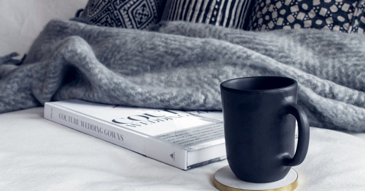 Why throw away so much sourdough starter? Tartine Book no. 3 - Black Ceramic Mug on Round White and Beige Coaster on White Textile Beside Book