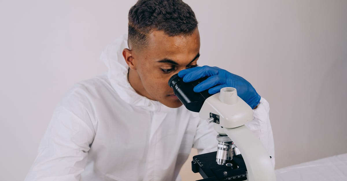 Why use gloves when handling food? - A Man in Coveralls Using a Microscope