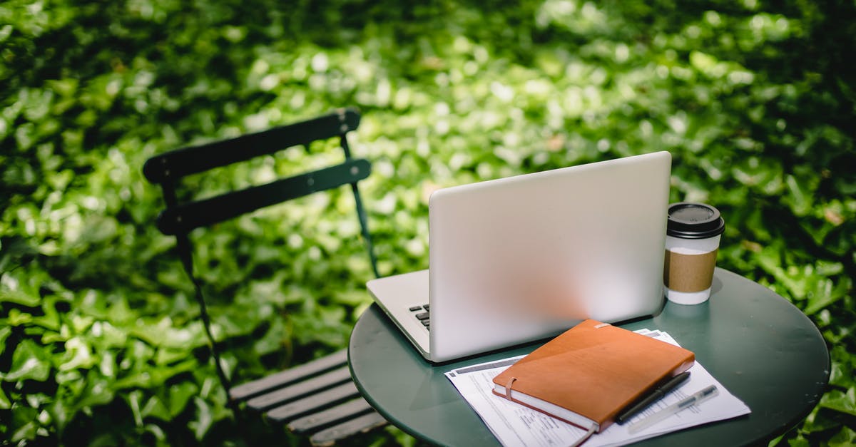 Why would hot-packed green beans go bad when still sealed? - Modern netbook with notebook placed on small round table near paper cup with hot drink in sunny green park