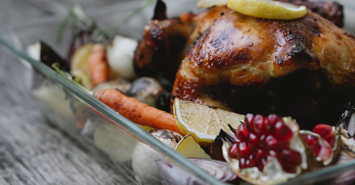 Will lemon in a cast-iron pan with roast chicken cause problems? - Appetizing roasted chicken with vegetables in baking dish