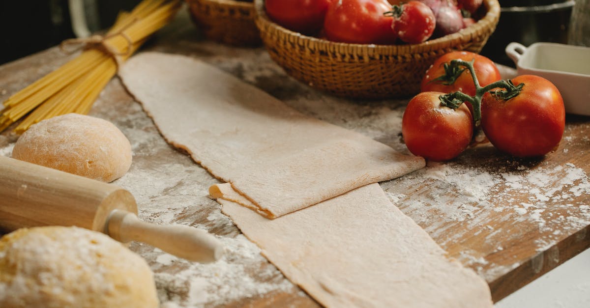 Won't fresh pasta sheets in lasagna overcook? - Raw dough on table with tomatoes