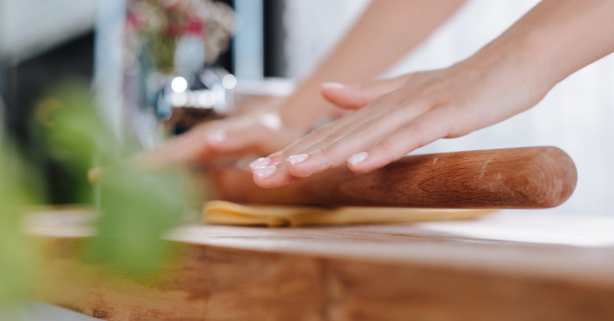 Wood versus marble rolling pin 'performance' - Hands Rolling Dough on Wooden Board