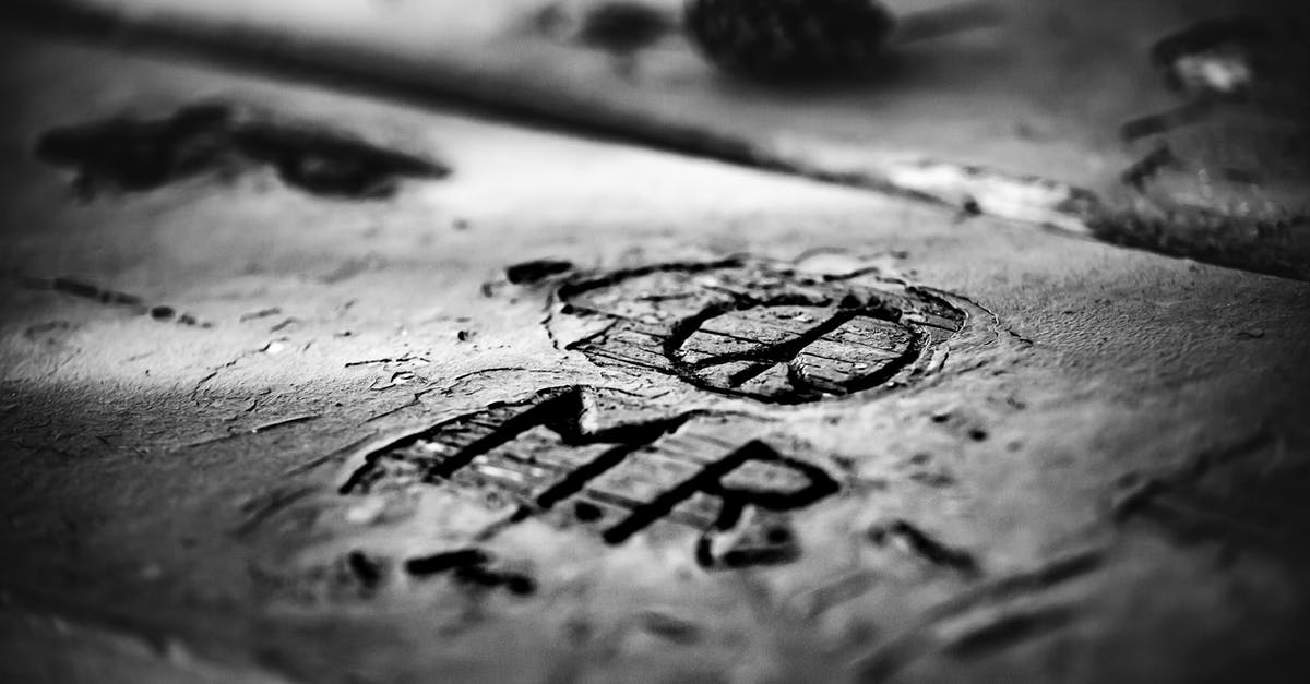 Wooden vs Anti Microbial Cutting Board For Carving Meat - From above closeup black and white of old rectangular wooden planks with uneven shabby surface and cut out letters near circle with lines inside in daylight