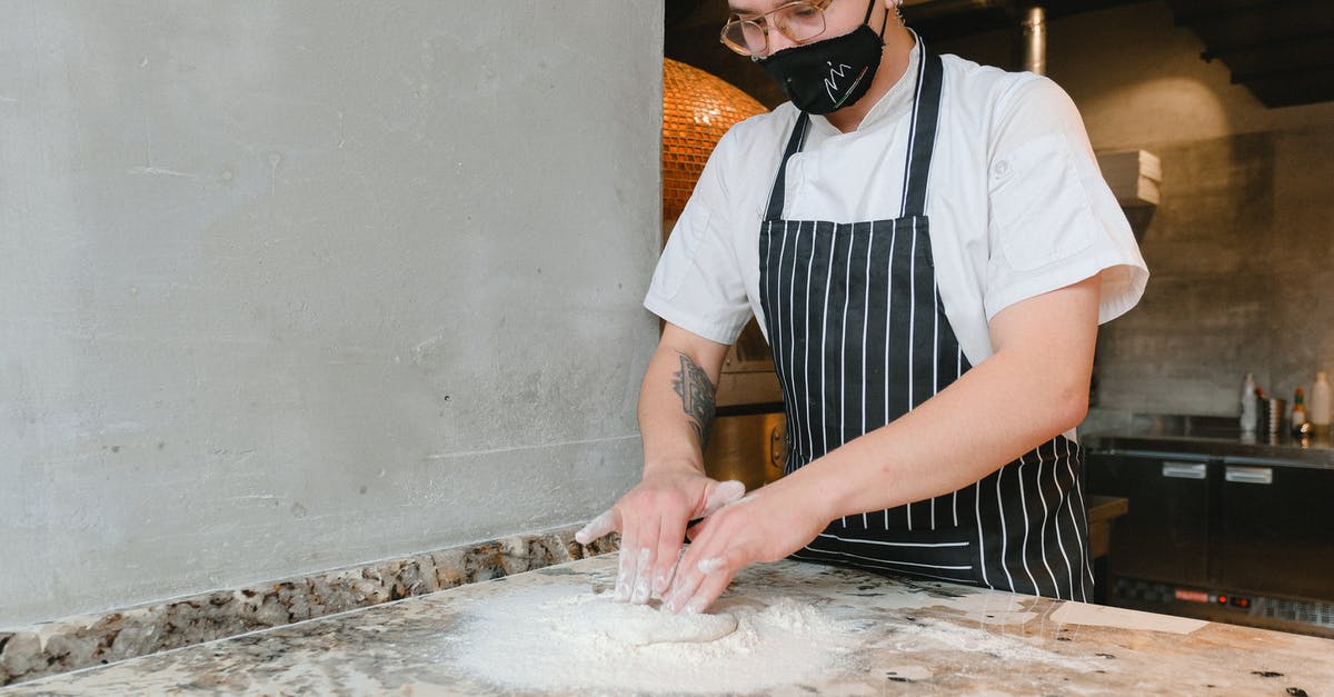 Working with dough - Man in Blue and White Polo Shirt Wearing Black Sunglasses