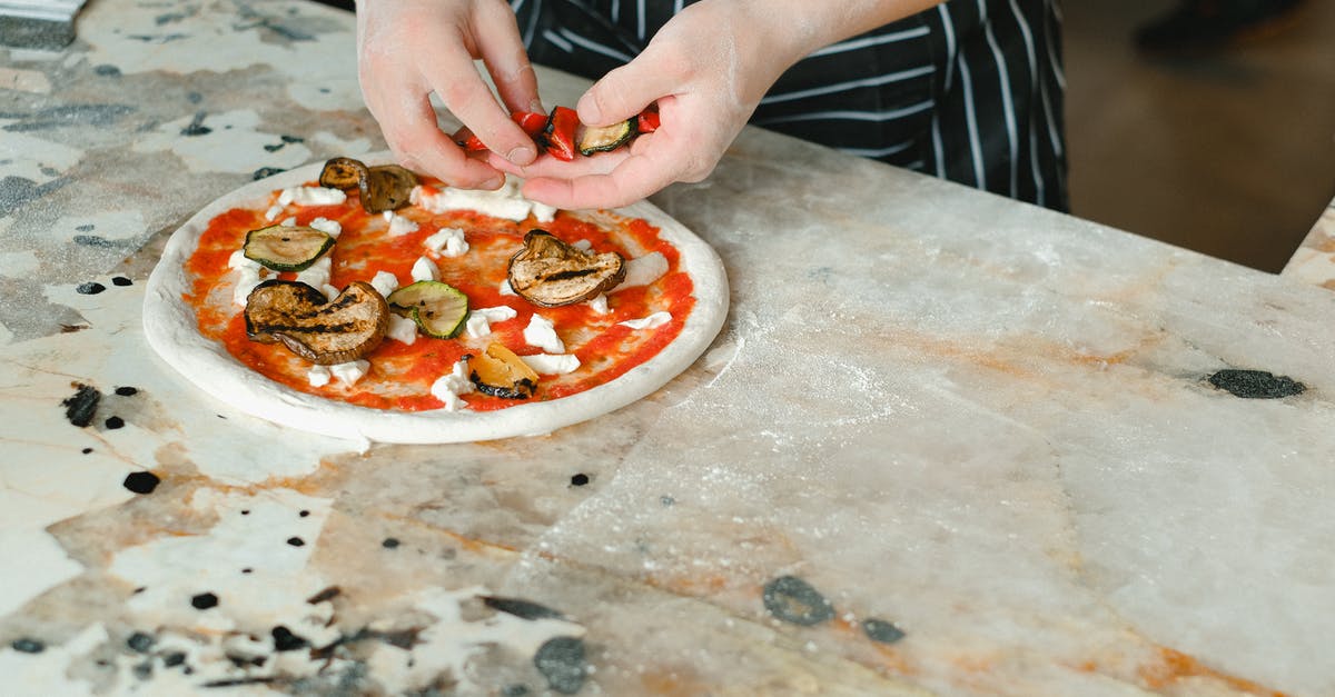 Working with sticky dough for pizza making - A Chef Toppings Pizza with Vegetables