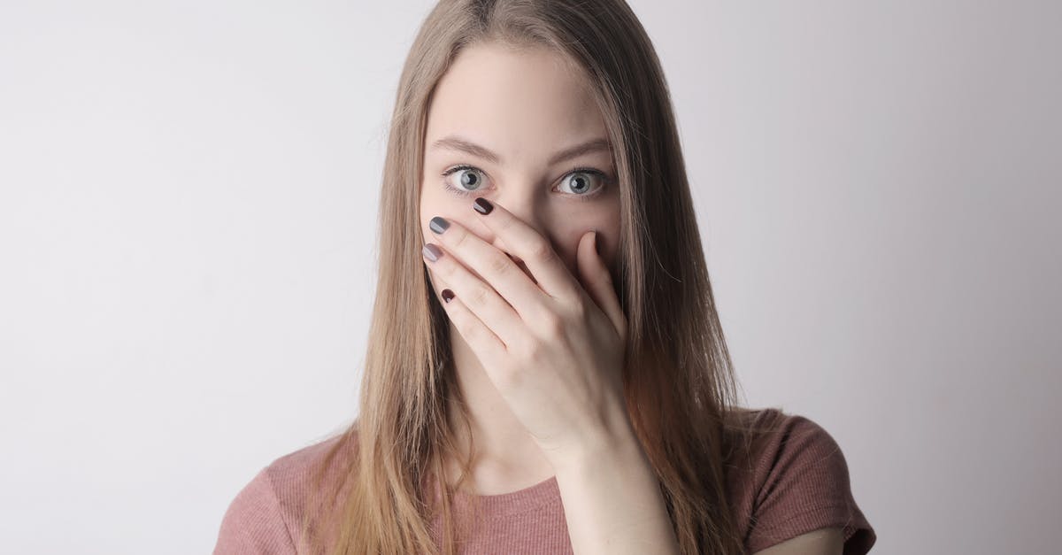 Worried about my Buddha hand rind ferment - Young amazed woman in casual wear covering mouth while keeping secret