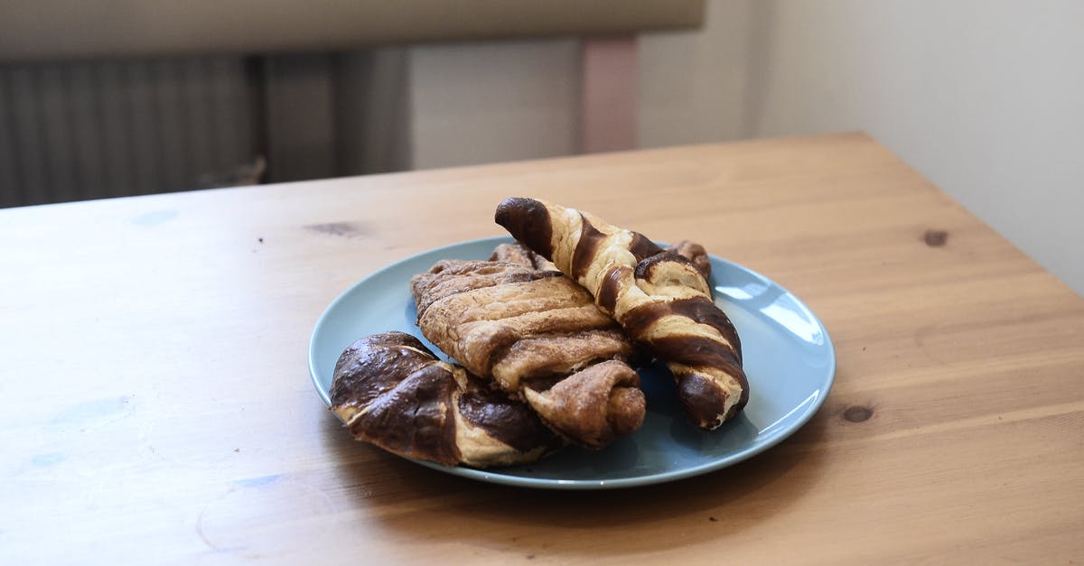 Would replacing sugar with a sweetener affect bread dough fermentation? - High angle of appetizing homemade croissants with milk chocolate topping on wooden table