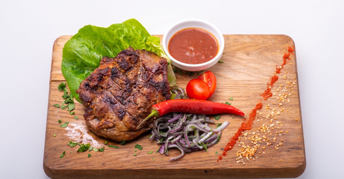 Would sous vide-ing tomatoes result in a deeply caramelised tomato sauce? - A Delicious Fried Pork with Onions and Chili  on a Chopping Board