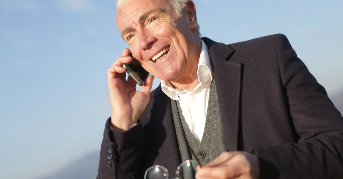 Would this be called matured cream? - Mature businessman having conversation on smartphone in city