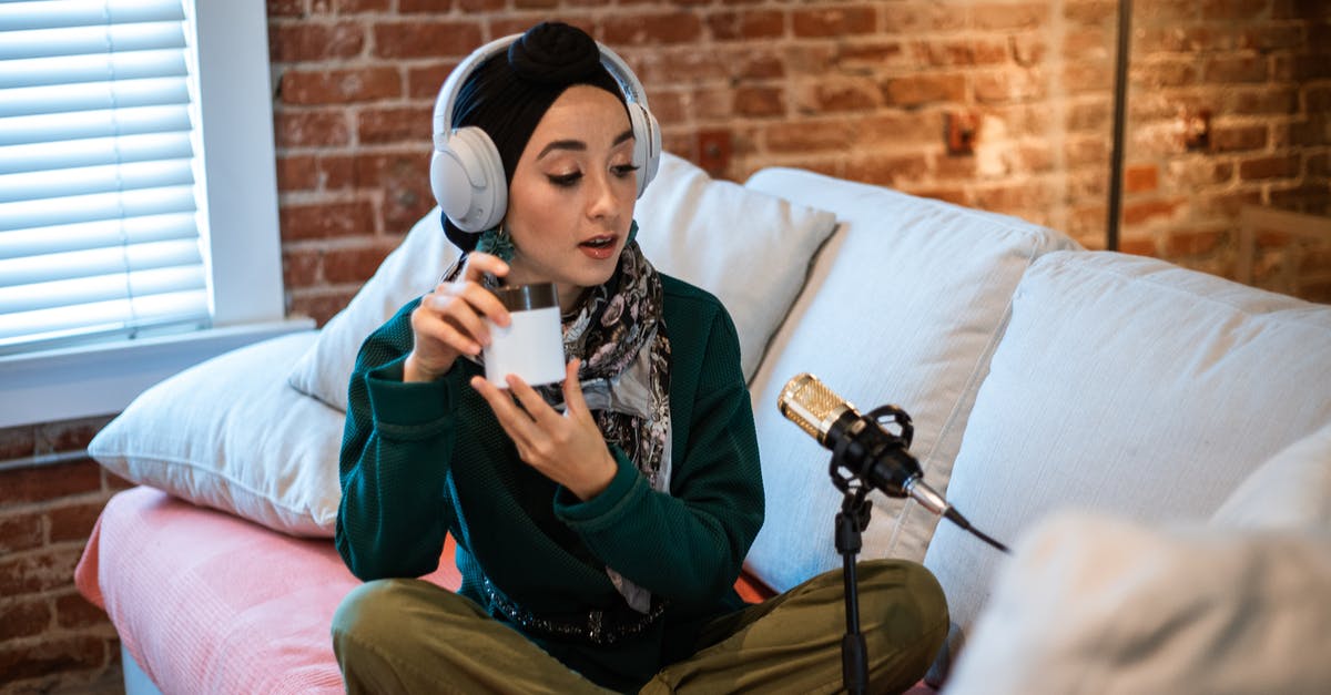 Would this be called matured cream? - Woman in Green Long Sleeve Shirt and Green Pants Sitting on Sofa Holding a Beauty Product