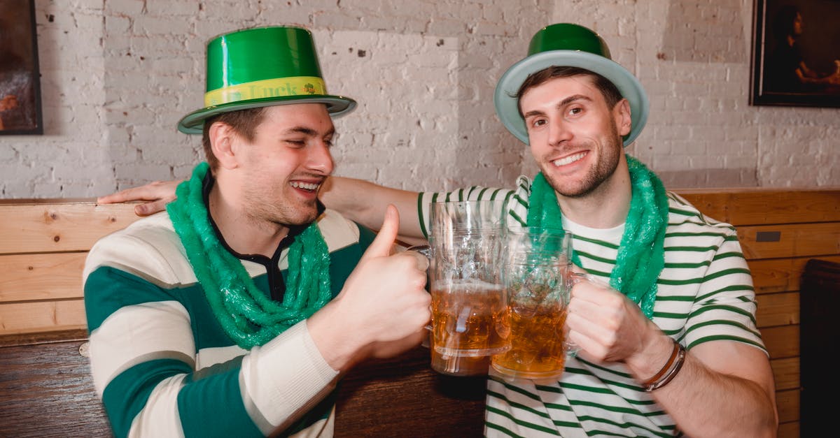 Yogurt-based sourdough smells like alcohol - Happy friends clinking mugs of beer on Saint Patricks Day